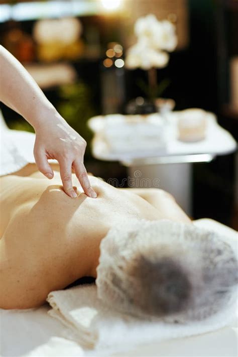 Closeup On Massage Therapist In Spa Salon Massaging Clients Back Stock