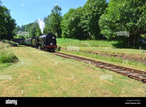 A Vintage Steam Train Emerging From A Tunnel On A Heritage Railway Line