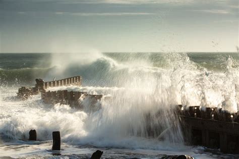 Seascape Of Angry Waves Crashing And Splashing Against Groyne Stock