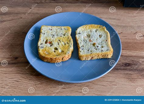 Two Slices Of Bread In A Plate On Vintage Wooden Background Stock Photo