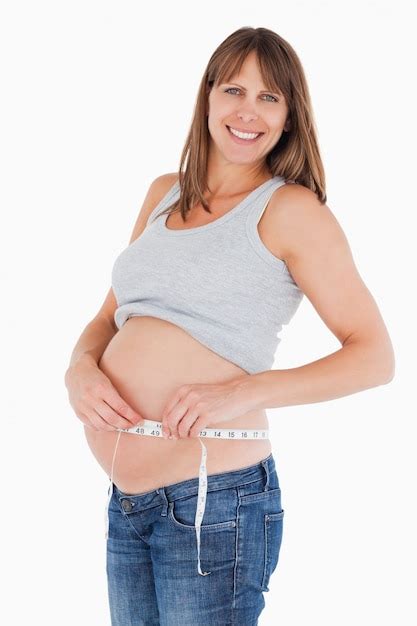 Premium Photo Beautiful Pregnant Woman Measuring Her Belly While Standing