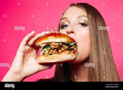Hungry Girl Biting Burger Stock Photo Alamy