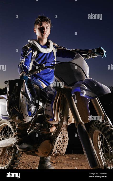 Confident On His Dirtbake Portrait Of A Young Motocross Rider Posing