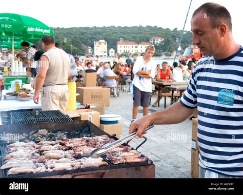 Fisherman Cooking Fish On The Quay During Ribarska Noc Fishermans Night