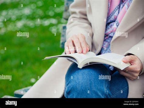 girl sitting on a bench and reading Stock Photo - Alamy