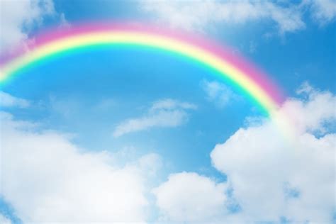 Premium Photo Rainbow In Blue Sky With Clouds