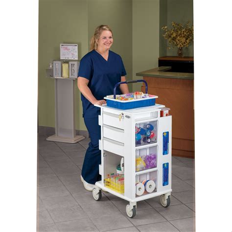 A Woman In Scrubs Standing Next To A White Cart