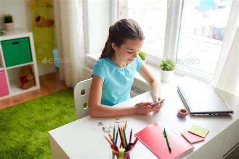 Girl With Smartphone Distracting From Homework Technology Photos