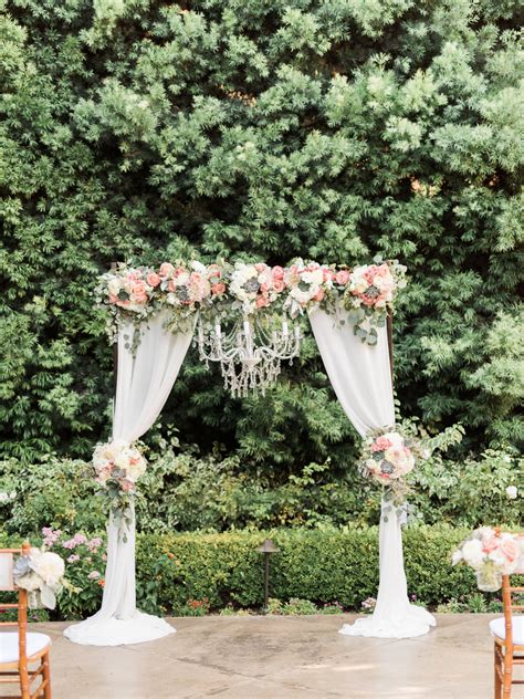 Wedding Ceremony Arch With Draping Fabric And Chandelier Succulents