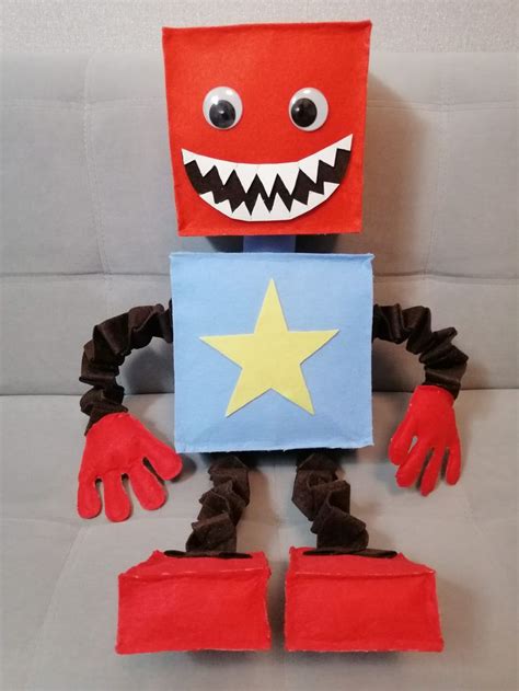 a red and blue paper bag with a yellow star on it's chest, arms and legs