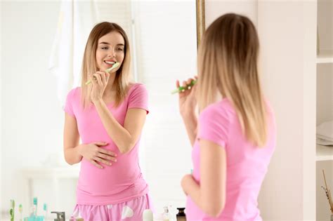 Beautiful Young Woman Brushing Her Teeth In Morning Angela Evanson