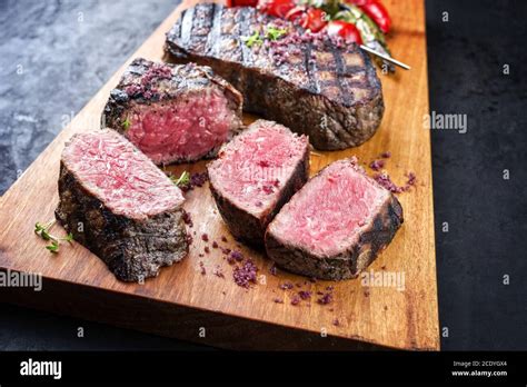 Barbecue Dry Aged Wagyu Roast Beef Steak With Tomatoes And Chili As Closeup On A Modern Design