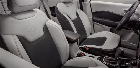 The Interior Of A Car With Grey And Black Seats