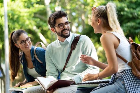 Happy Group Of Friends Studying And Talking Together At University