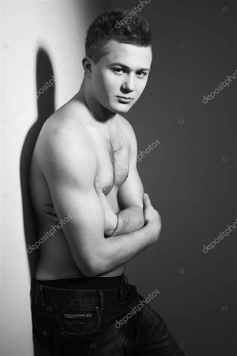 Shirtless Handsome Man With Fit Body Lean Against A Wall Indoor Black