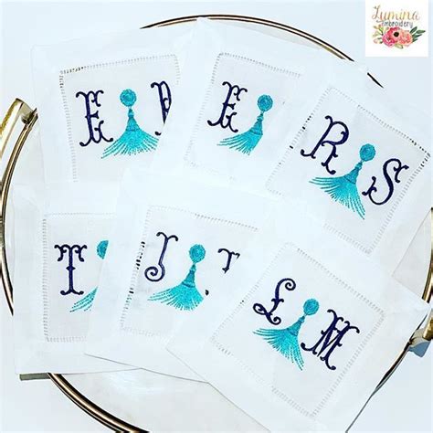 Four Embroidered Monogrammed Napkins On A Plate