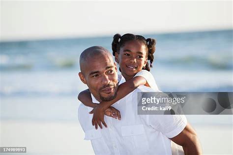 Black Father Carrying Daughter On Shoulders At Beach Photos And Premium