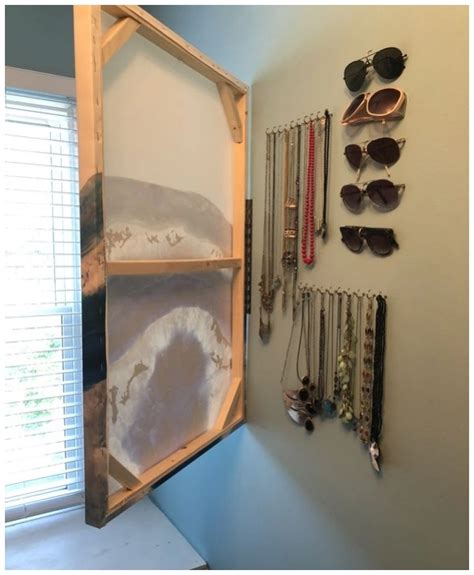 A Wall Mounted Jewelry Rack With Sunglasses On It