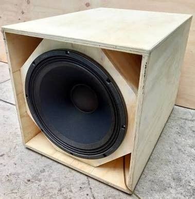 A Wooden Box That Has Some Speakers Inside Of It On The Concrete Floor