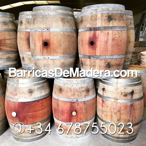 Several Wooden Barrels Stacked On Top Of Each Other In A Storage Area