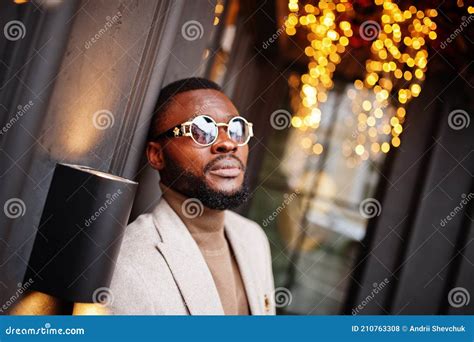 Stylish African American Man Wear Beige Jacket With Sunglasses Pose