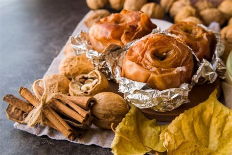 Free Photo Baked Apples In Foil On Plate With Walnuts