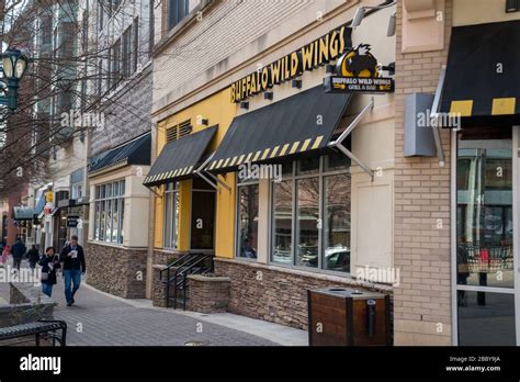 Buffalo Wild Wings restaurant location on street with people walking by ...