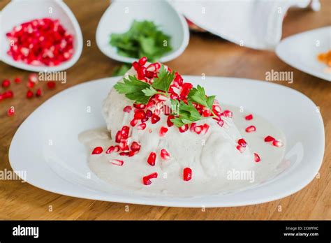 chiles en nogada, traditional Mexican dish with poblano chili peppers ...