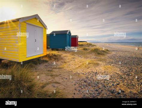 Sunflare Over Findhorn Beach Huts Stock Photo Alamy