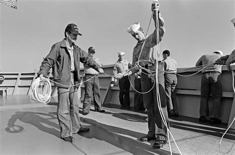 Crewmen And Navy League Sea Cadets Handle Heaving Lines Aboard The