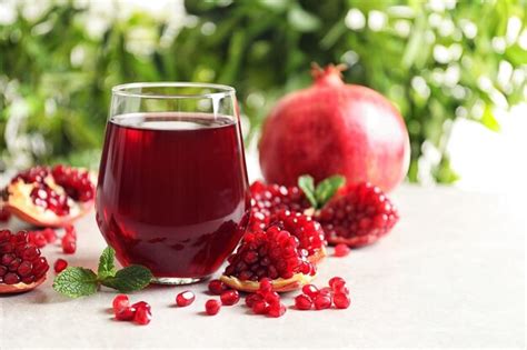 Premium Photo Composition With Glass Of Fresh Pomegranate Juice On