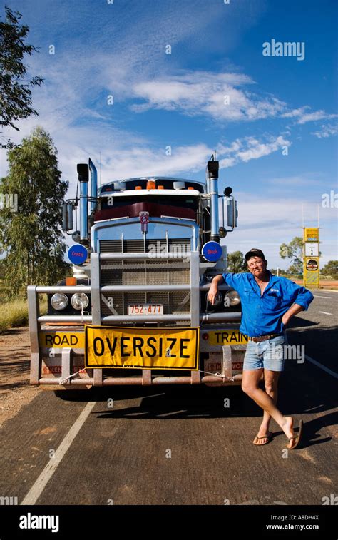 Driver Posing In Front Of Oversized Roadtrain Truck On Stuart Highway