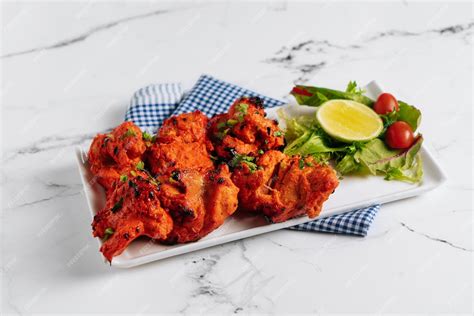 Premium Photo Bbq Chicken Tikka Boti With Lime In A Dish Isolated On Napkin Side View On Grey