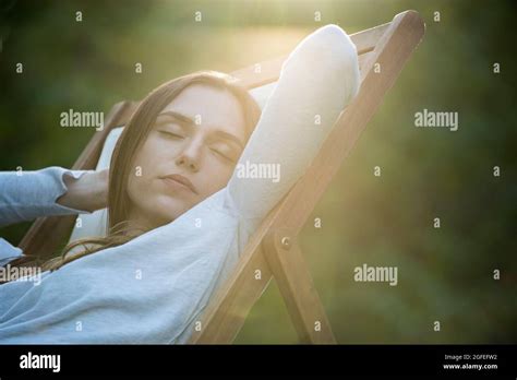 Young Woman Sleeping On Chair In Park Stock Photo Alamy