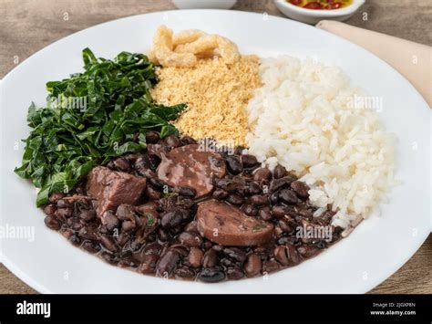 Typical Brazilian Feijoada With Rice Pepper Farofa Kale And