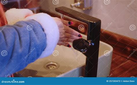 Unrecognizable Woman Washing Hands In Washbasin Body Part Of Female In