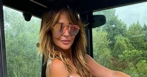 Lizzie Cundy wows as she poses in plunging swimsuit on tractor for ...