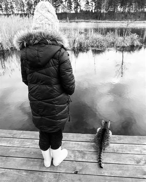 Premium Photo Rear View Of Woman Standing On Pier Over Lake