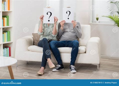 Couple Holding Question Mark Sign In Front Of Face Stock Image Image Of Couch Male 218837815