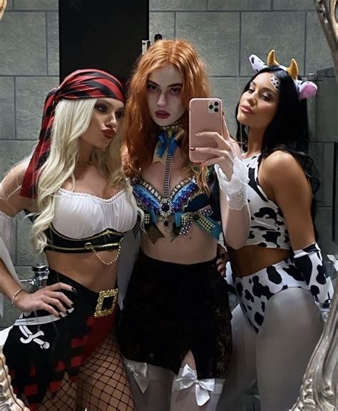 Three Women Dressed Up In Costumes Taking A Selfie