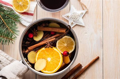 Mulled Wine Hot Drink With Citrus Apple And Spices In Aluminum Casserole And Fir Branch On