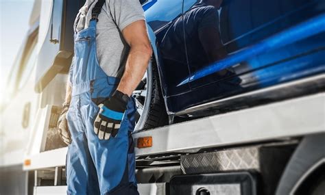 Premium Photo | Professional towing truck driver staying next to his ...