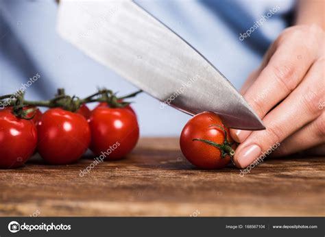 Woman Cutting Cherry Tomatoes — Stock Photo © Edzbarzhyvetsky 168567104