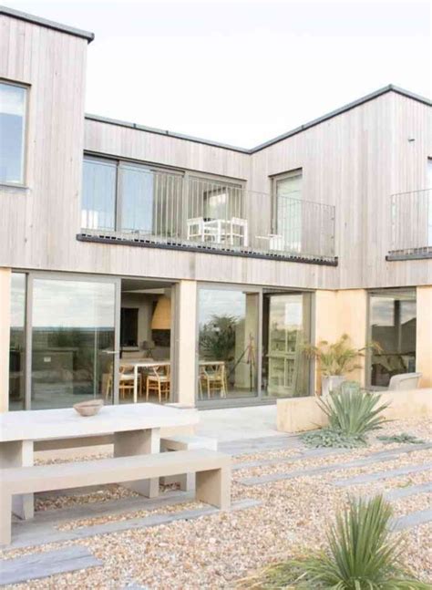 A House That Has Some Benches In Front Of It