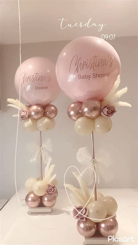 Two Pink And White Balloons On Top Of Each Other In Front Of A Mirror