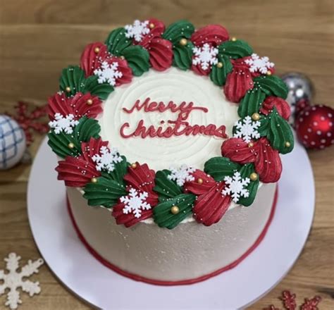 A Decorated Christmas Cake Sitting On Top Of A White Plate