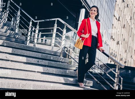 Photo Of Dreamy Adorable Mature Lady Leader Wear Red Jacket Walking