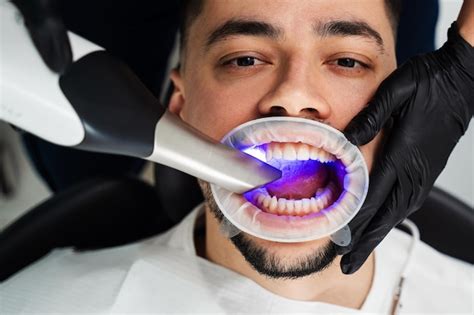 Premium Photo Doctor Examines Teeth Of Patient With Xray Scanning