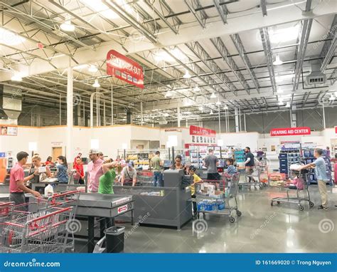 Regular And Self Checkout Kiosks Area With Busy Customers Of Costco In