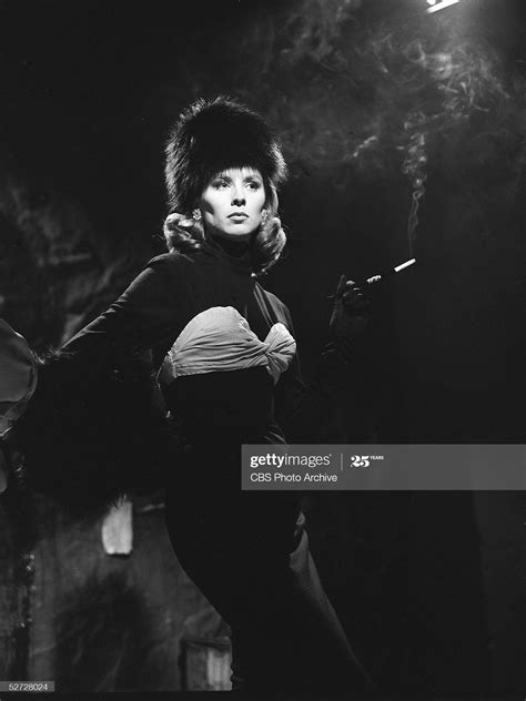 American Model And Actress Suzy Parker Poses Glamorously And Holds A